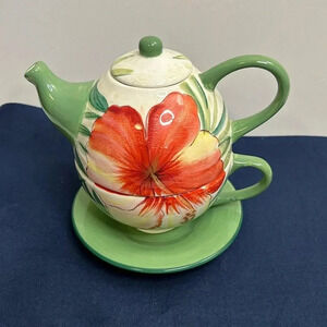 Adorable Island Plantations teapot with cup and saucer.